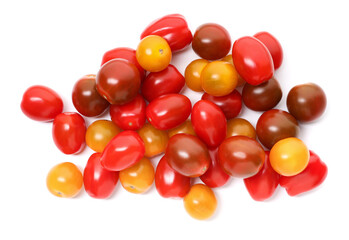 Obraz premium Heap of different ripe juicy tomatoes isolated on white, top view