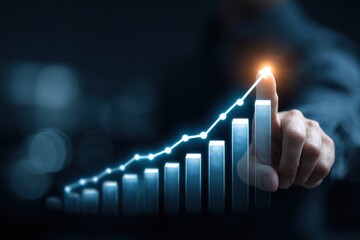 Hand points to a rising graph, symbolizing growth