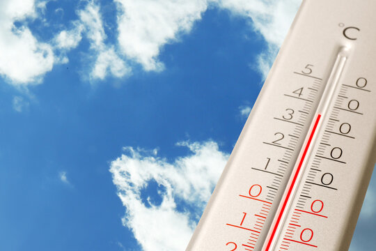 High temperature on thermometer against blue sky on sunny day. Summer weather - Powered by Adobe