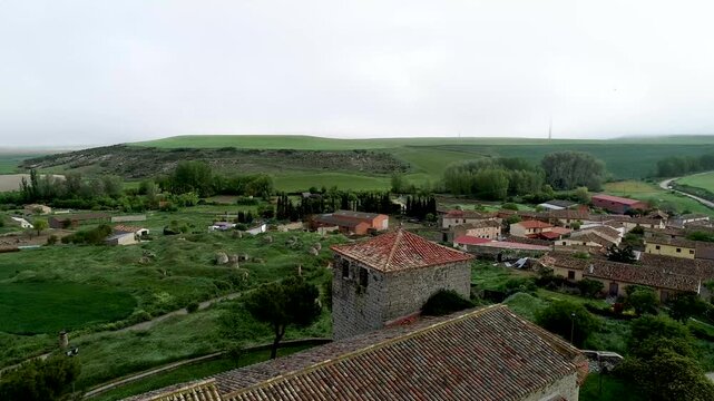 Bell tower of Iglesia de San Fructuoso in Valoria del Alcor Palencia under misty sky