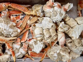 Frozen king crab claws in the freezer for sale in the supermarket. Delicatessen meat for a healthy diet. Close-up