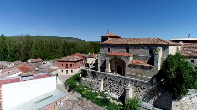 San Roman Church in Cobos de Cerrato surrounded by rustic village rooftops