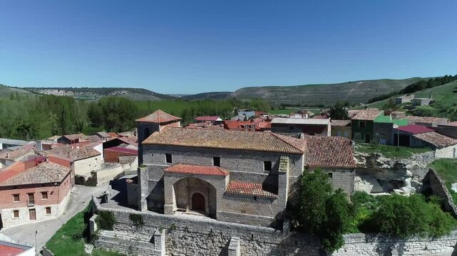 San Roman Church in Cobos de Cerrato surrounded by rustic village rooftops