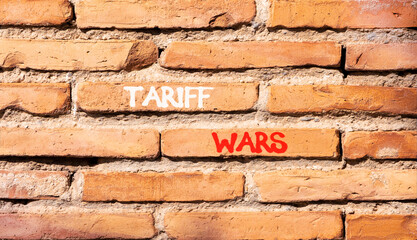 Trade tariff wars symbol. Concept word Tariff wars on beautiful old brown brick wall. Beautiful old...