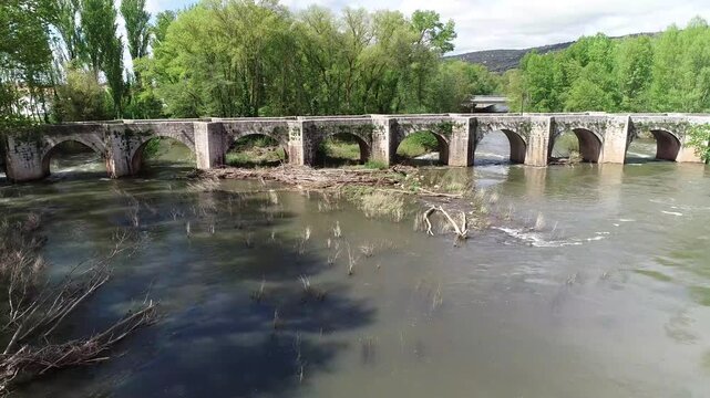 Aerial view of Renaissance stone bridge over Arlanza River in Quintana del Puente