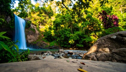 Waterfall cascading into a lush tropical forest