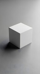 Clean white cube sitting on a gray surface casting a subtle shadow perspective view