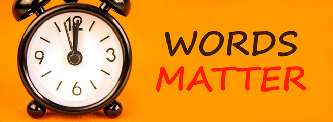 Words matter symbol. Concept word Words matter on beautiful orange paper. Beautiful black alarm...