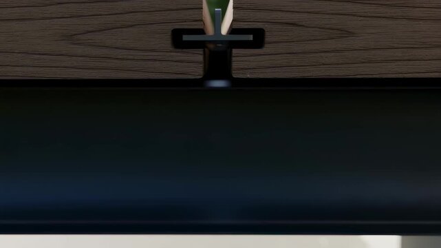 Slowmotion closeup revealing hidden clip locking mechanism securing new composite decking boards tightly in place outdoors.