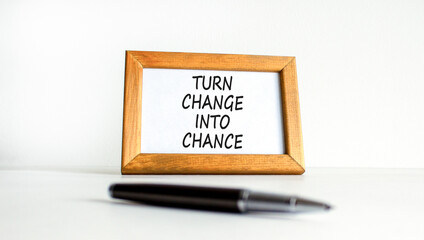 Turn change into chance symbol. Concept words phrase Turn change into chance on beautiful wooden picture frame. Beautiful white background. Business Turn change into chance concept. Copy space.