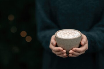 Warm beverage in cozy hands evokes comfort and tranquility in so
