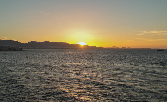Fototapeta Scenic panoramic seascape view of Ocean and clouds and blue hour twilight sky in Piraeus Athens, Greece seen from outdoor deck of luxury cruiseship cruise ship liner