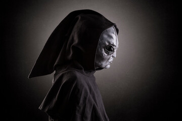 Mysterious humanoid alien at night over dark misty background