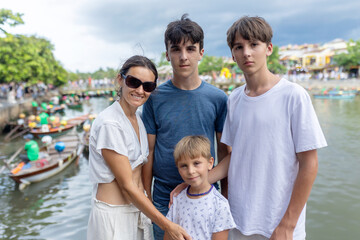 Happy european family, visting Hoi An city in Vietnam for a summer vacation, trying traditional food na watching the show in Memories Land