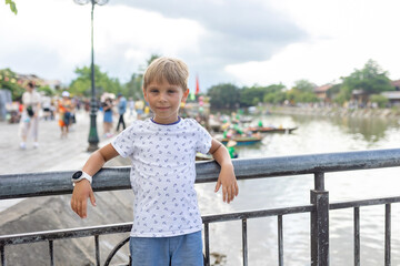 Happy european family, visting Hoi An city in Vietnam for a summer vacation, trying traditional food na watching the show in Memories Land