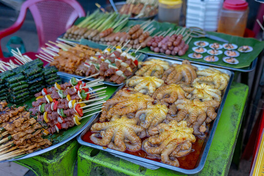 Happy european family, visting Hoi An city in Vietnam for a summer vacation, trying traditional food na watching the show in Memories Land