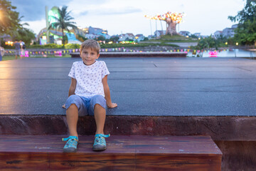 Happy european family, visting Hoi An city in Vietnam for a summer vacation, trying traditional food na watching the show in Memories Land