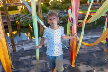 Happy european family, visting Hoi An city in Vietnam for a summer vacation, trying traditional food na watching the show in Memories Land