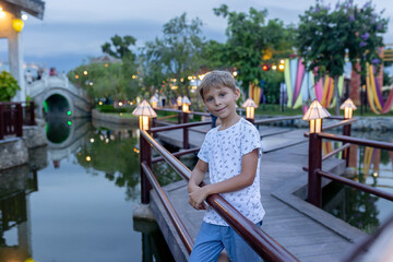 Happy european family, visting Hoi An city in Vietnam for a summer vacation, trying traditional food na watching the show in Memories Land