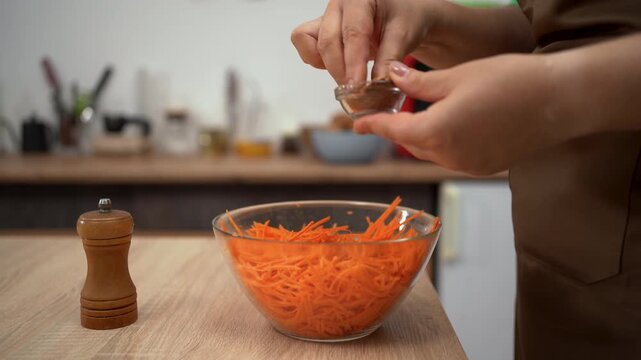 Preparing bright salad with grated carrots. ideal for cooking.