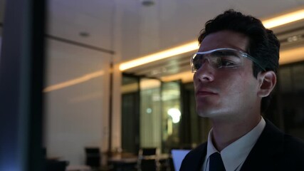 Professional cybersecurity analysts monitoring server data in dark office. Female developer pointing at code while collaborating with male colleague on urgent software project late at night. - Powered by Adobe