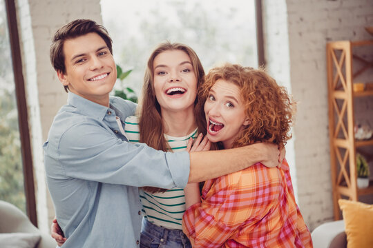 Group of close friends sharing joyful moments together in a cozy home setting during daytime