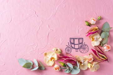 Fototapeta premium A flat lay composition with orchids, roses, eucalyptus, and ylang-ylang on a pink textured background for greeting cards, posters, or invitations. Includes a hand-drawn vintage carriage. 