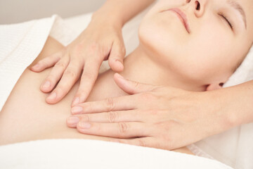 Relaxing spa massage for young caucasian female with calming atmosphere and gentle hands.