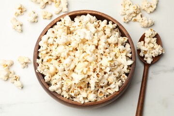 Tasty popcorn on white table, flat lay