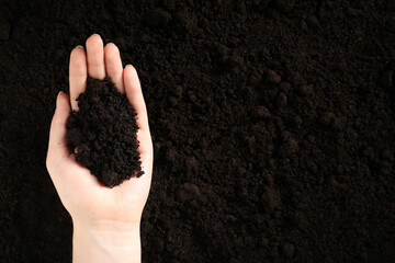 Woman with pile of fresh soil, top view