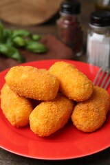 Many delicious fried croquettes on table, closeup