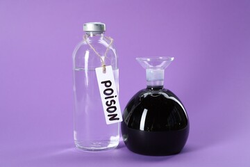 Glass bottles with poisons on violet background