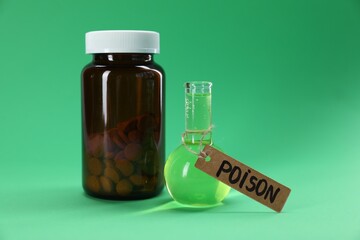 Bottles with poisons on green background, closeup