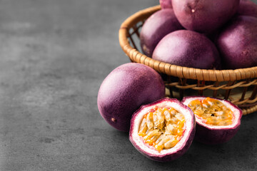 Fresh passion fruits on grey table, closeup. Space for text
