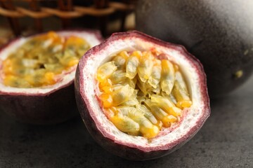 Fresh passion fruits on grey table, closeup