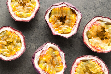 Fresh passion fruits on grey table, flat lay