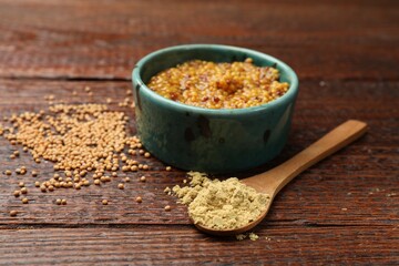Different types of mustard on wooden table, closeup
