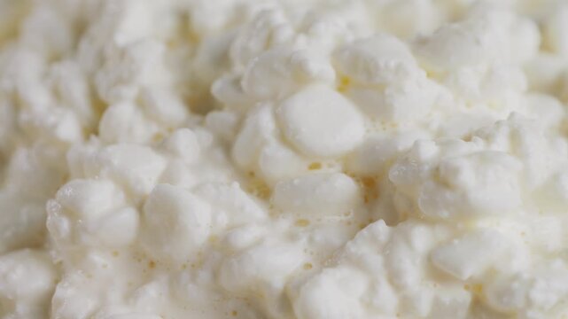 Fresh homemade cottage cheese in a bowl with a spoon, homemade dairy products. High quality 4k footage