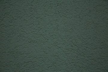 Dark green coarse grain plaster surface