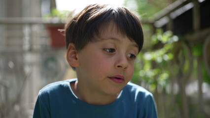 Young boy outdoors, gazing to the side with a curious expression, a moment of wonder and contemplation. the natural curiosity and attentiveness of childhood-SD 480p © Marco