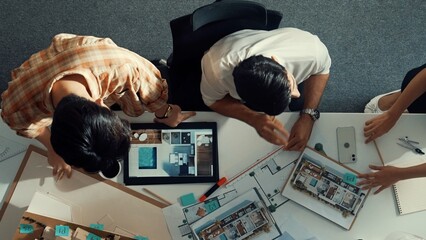 Top down view of skilled business man and colleague design house together. Aerial view of architect engineer working and measuring building structure by using architectural equipment. Alimentation.