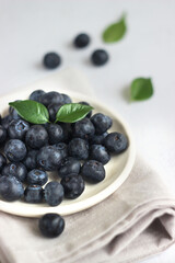 Blueberries are lying in a plate on the table