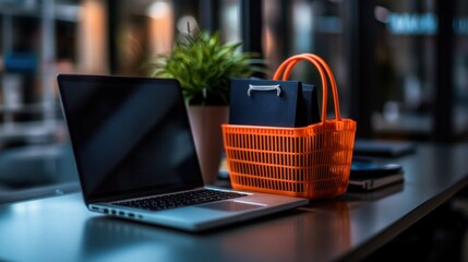 Laptop, plant, and shopping basket with a gift bag on a desk, suggesting online shopping.