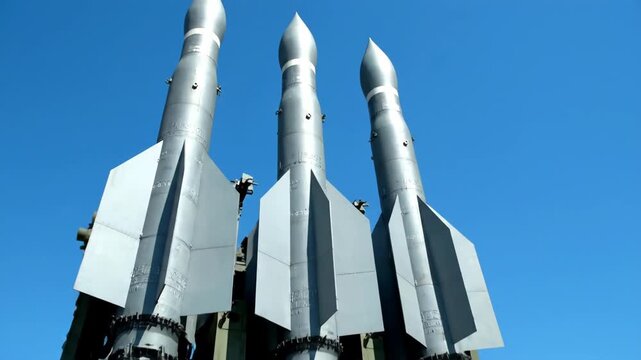 Five surface-to-air missile launchers against clear blue sky