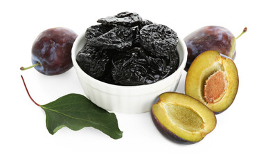 Dried prunes, fresh plums and green leaf isolated on white