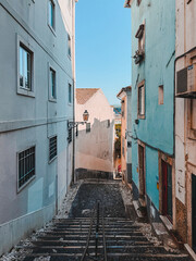 Narrow cobblestone stair street between colorful houses