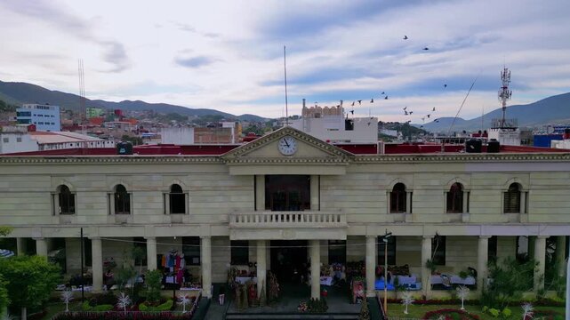 Aerial dronie shot from Chilpancingo's cultural center, revealing urban skyline and morning sky