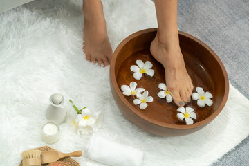 Panorama top view woman indulges in blissful foot massage at luxurious spa salon while masseur give reflexology therapy in gentle day light ambiance resort or hotel foot spa. Quiescent