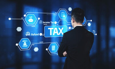 A business professional stands facing a digital interface displaying tax-related concepts, including income tax and refunds, set in a modern office environment. Tessel