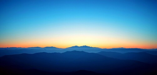 Fototapeta premium Serene mountain layers fade into soft twilight sky, inspiring peace and natural beauty.